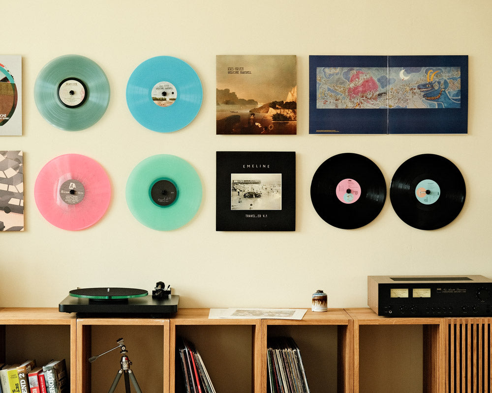 A nice collection of record albums and colored vinyl records, also showing a double album inside out