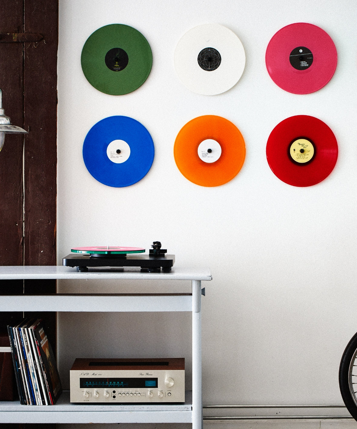 Vinyl records mounted to the wall using the Twelve Inch Adapter, in a minimalist room