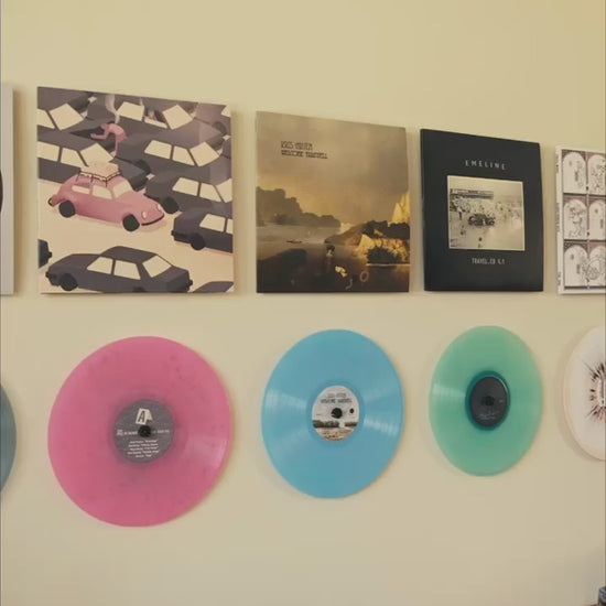 Video of album covers and colored vinyl records on the wall