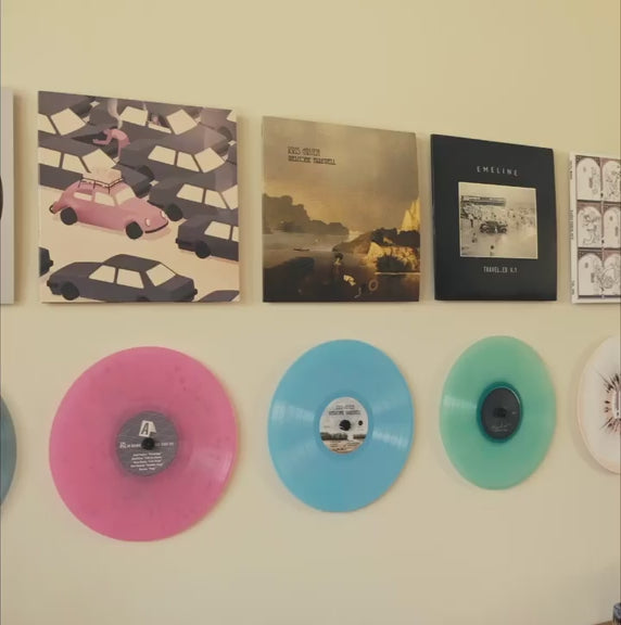 Video with both album covers and colored vinyl record on the wall