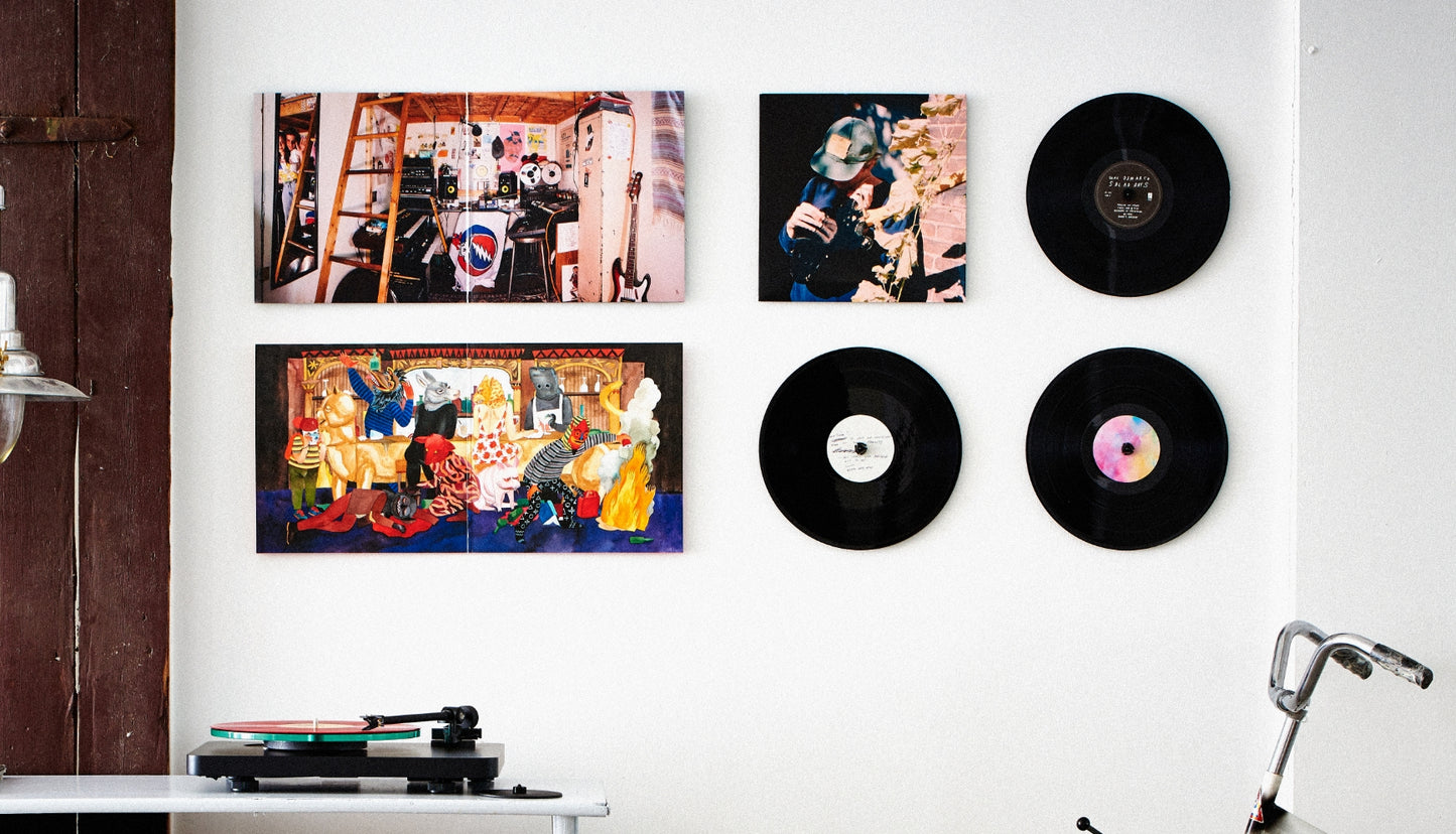 twelve inch on the wall with album and vinyl